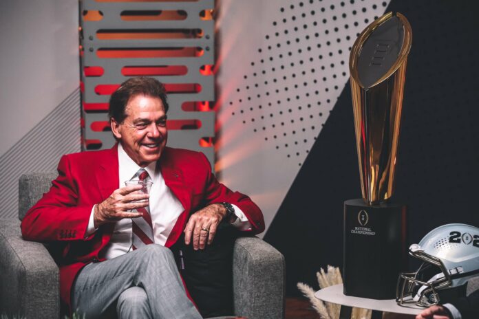 nick-saban-smiling-looking-at-trophy Nick Saban smiling at college football trophy