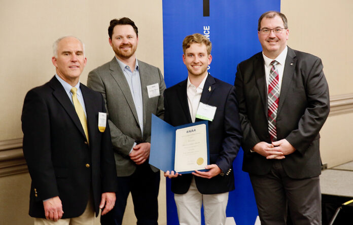 Thomas Clark, third from left, receives his AIAA award. With Clark from left to right are Dr.