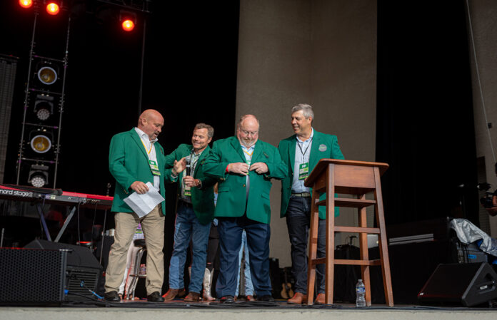 HH Chairmen Hank Isenberg and Bill Roark receiving Classic green coats