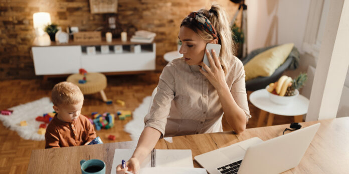 Female entrepreneur talking on the phone while being with her so